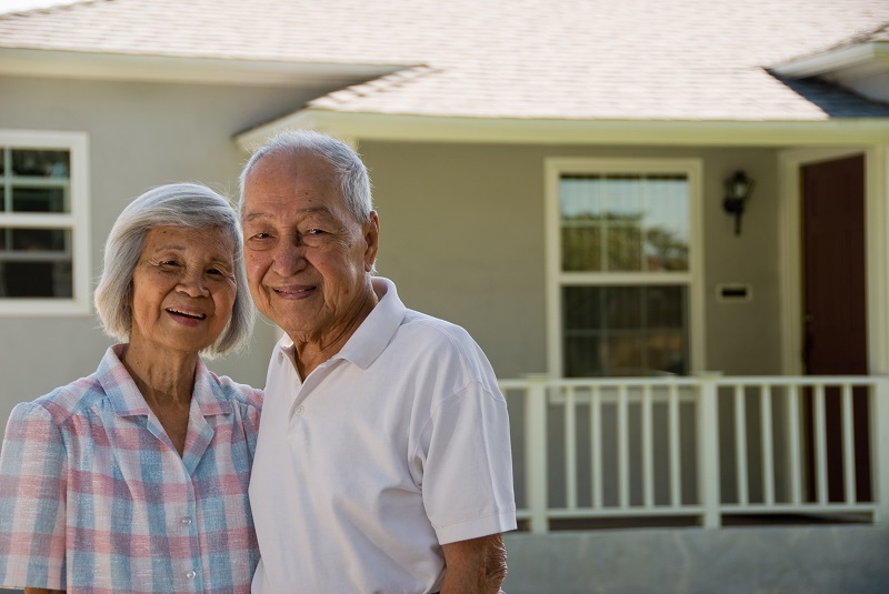 Grandparents in front of Home