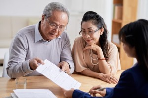 Senior couple studying real estate with profressional