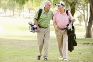 Two Senior Friends Enjoying A Game Of Golf