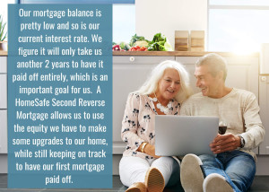 senior couple sitting on floor of kitchen looking a laptop